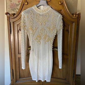 Gorgeous white pearl studded dress with rhinestone jewelry.